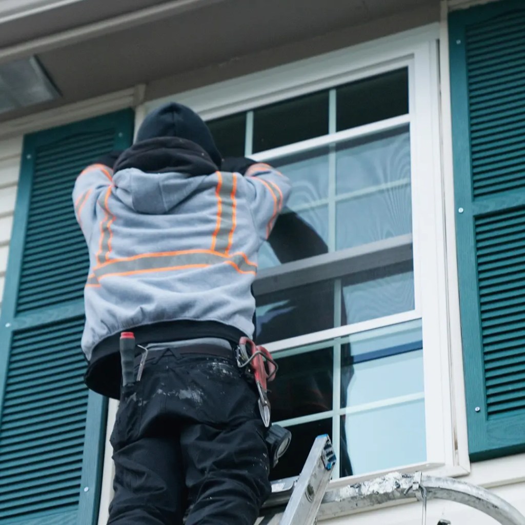 Front page Window installer retrofitting a window