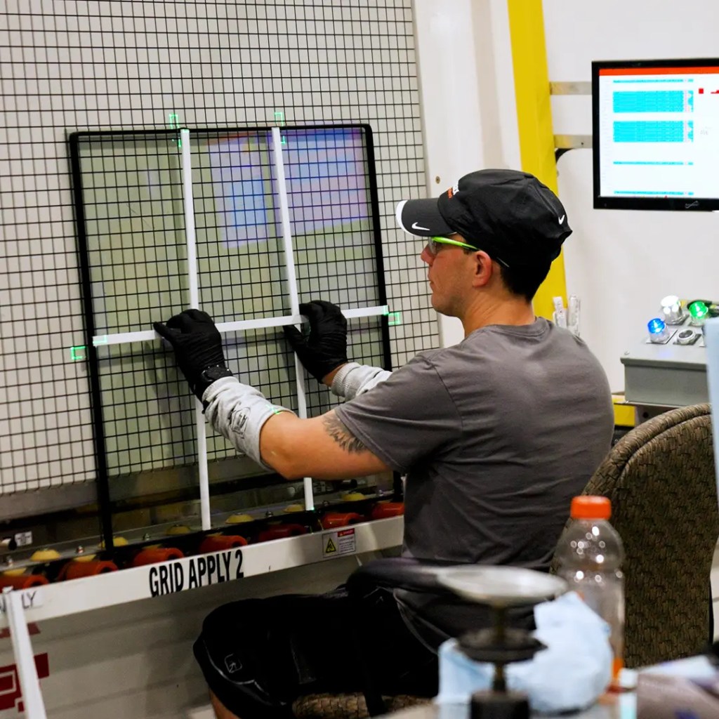 Front page Window manufacturer doing fitments on the window glass